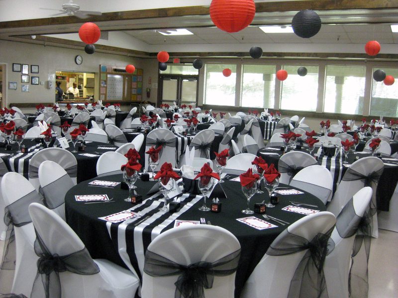 senior center multipurpose room set up with elegant red black and white decorations